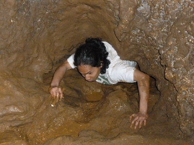 photo of man exploring a cave